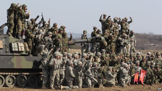 South Korean and U.S. army, gray, soldiers cheer after a live fire drill during the annual Foal Eagle maneuvers near Rodriguez Range in Pocheon, south of the demilitarized zone that divides the two Koreas, South Korea, March 15, 2012.